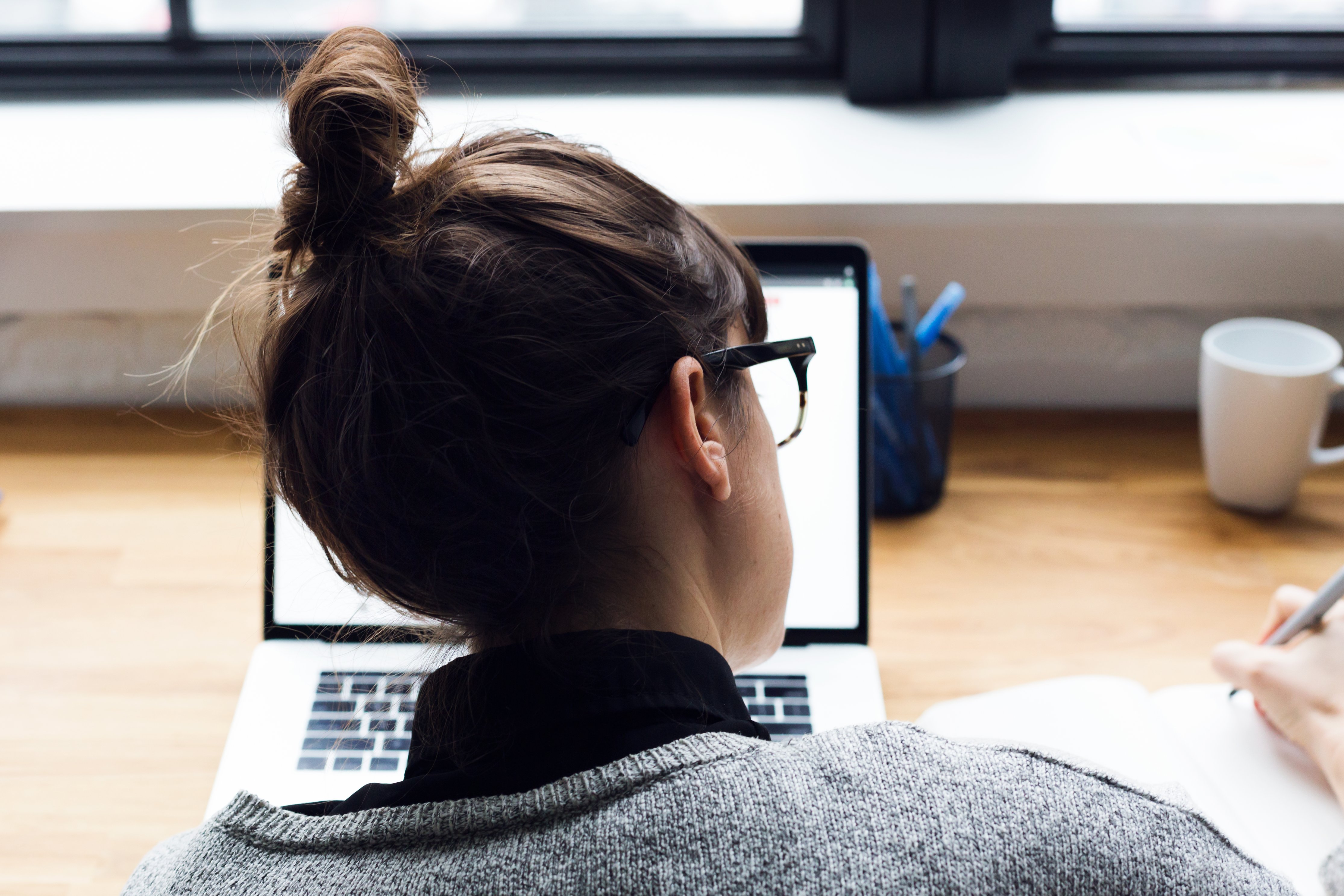 Female working on mathematics for online exam