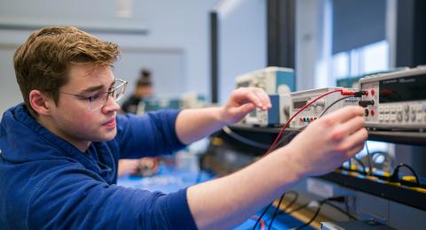 Electrical engineering major student working in electronics lab