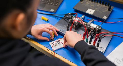Students hands working on an ECG 