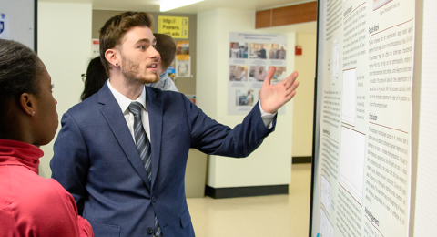 Chemistry major student explaining their chemistry research poster