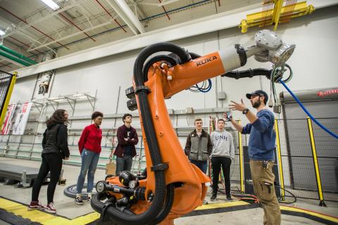 Staff explaining machines to students