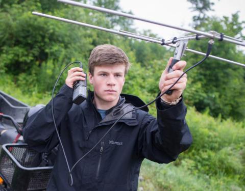 Graduate student doing field research outside