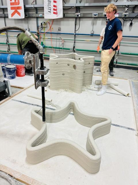 Olson Center interns helping to print the 3D starfish in the high bay. 