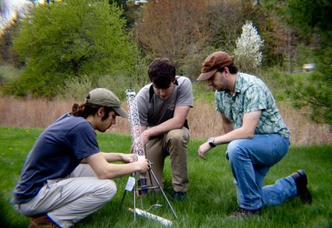 UNH Interns with the trebuchet they designed and built at the Olson center