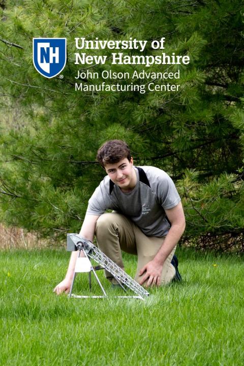 UNH Intern with the trebuchet they designed and built at the Olson center