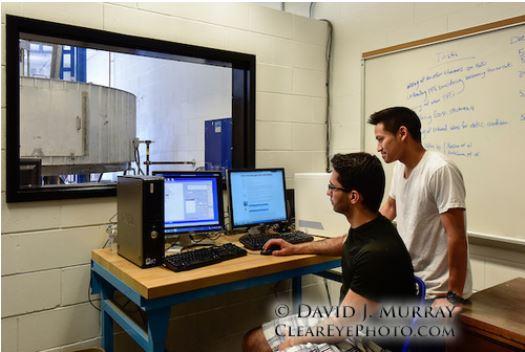 students working machine in lab