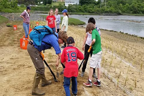 Dr. Gregg Moore works with volunteers on the Cutts Cover restoration project.